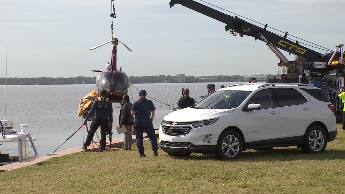 Watch: Crews hoist crashed helicopter from bay